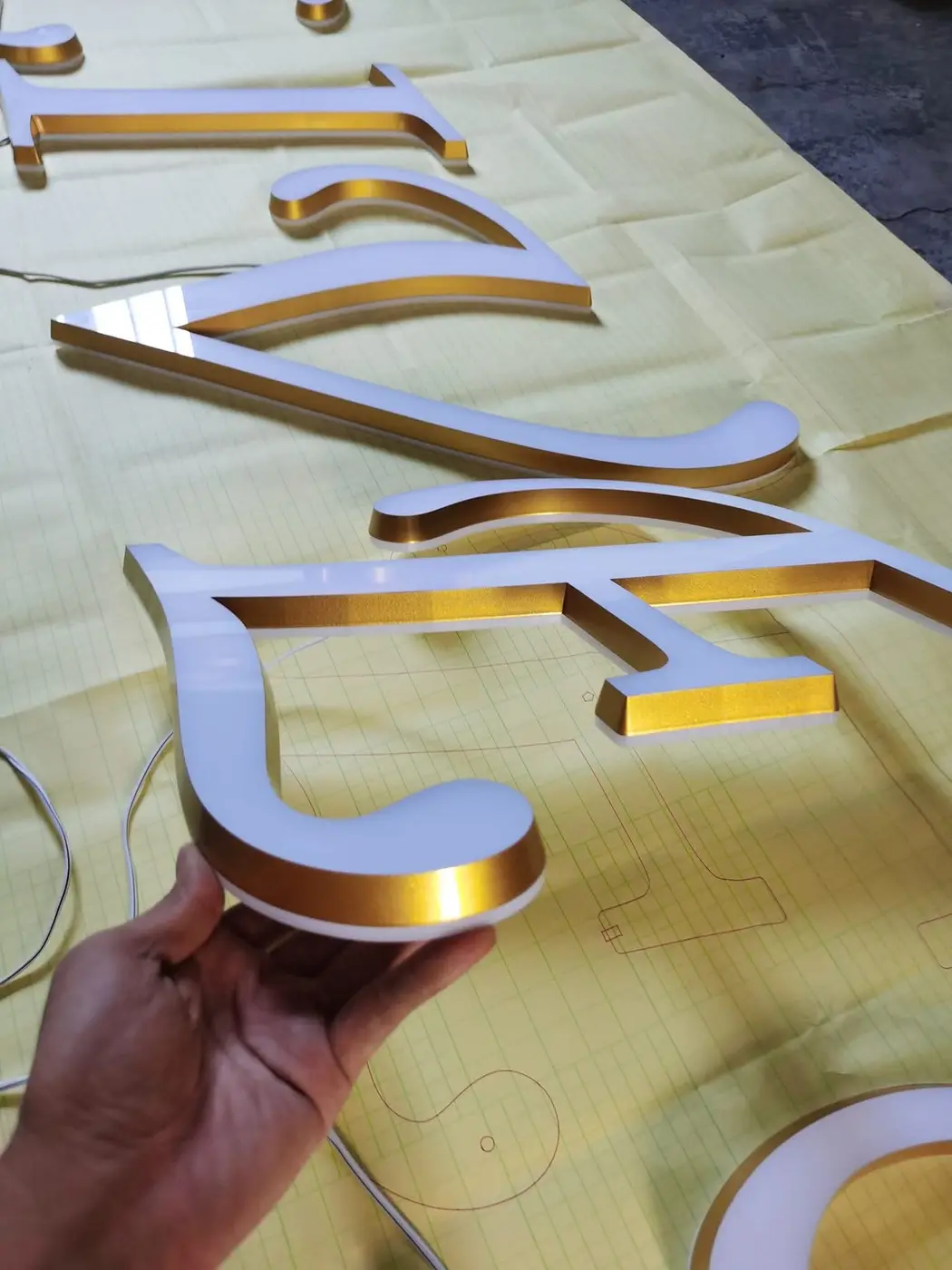 Gold and white acrylic signage letters